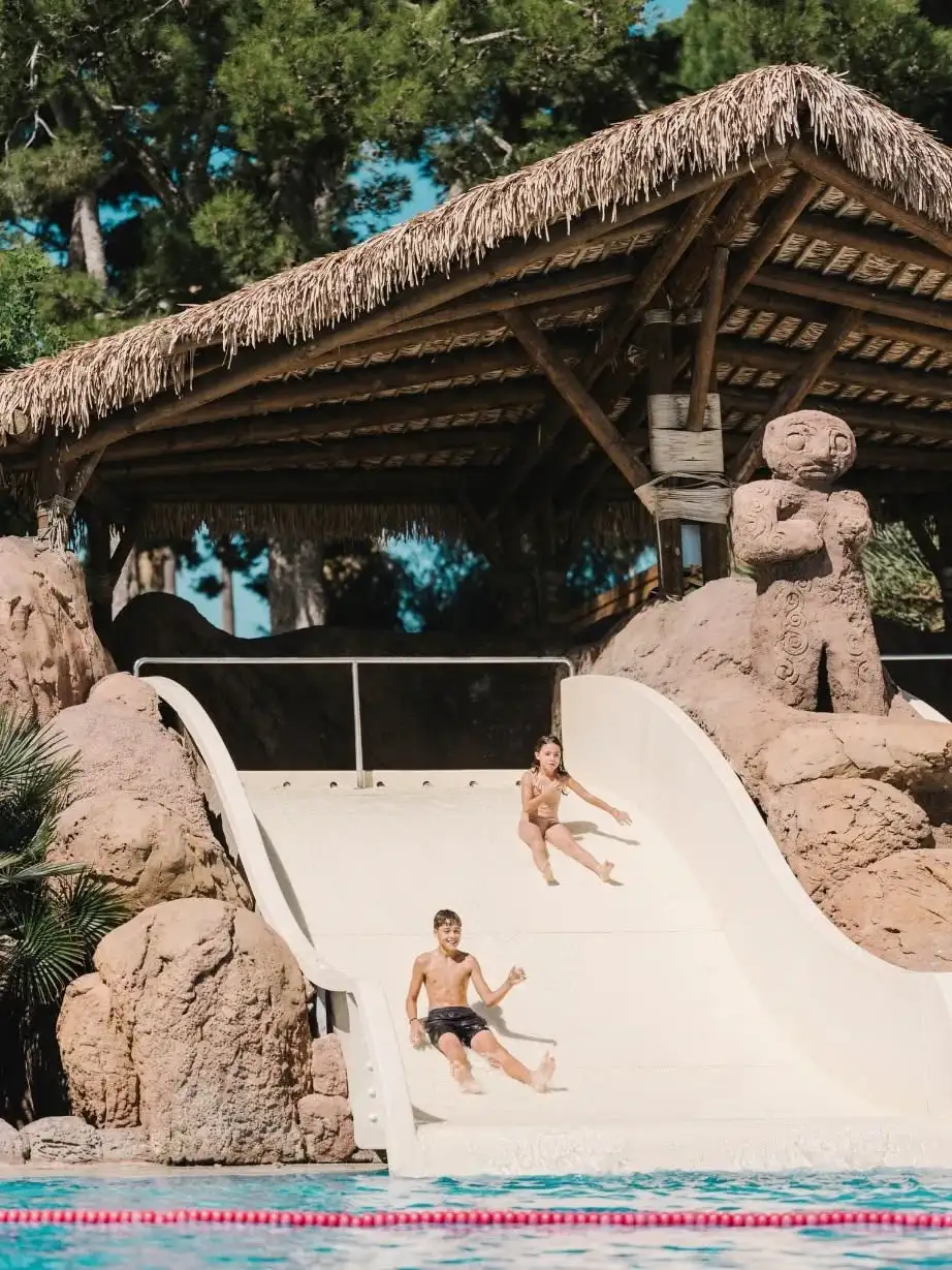 Kids on the waterslide at Cambrils Park Resort pool