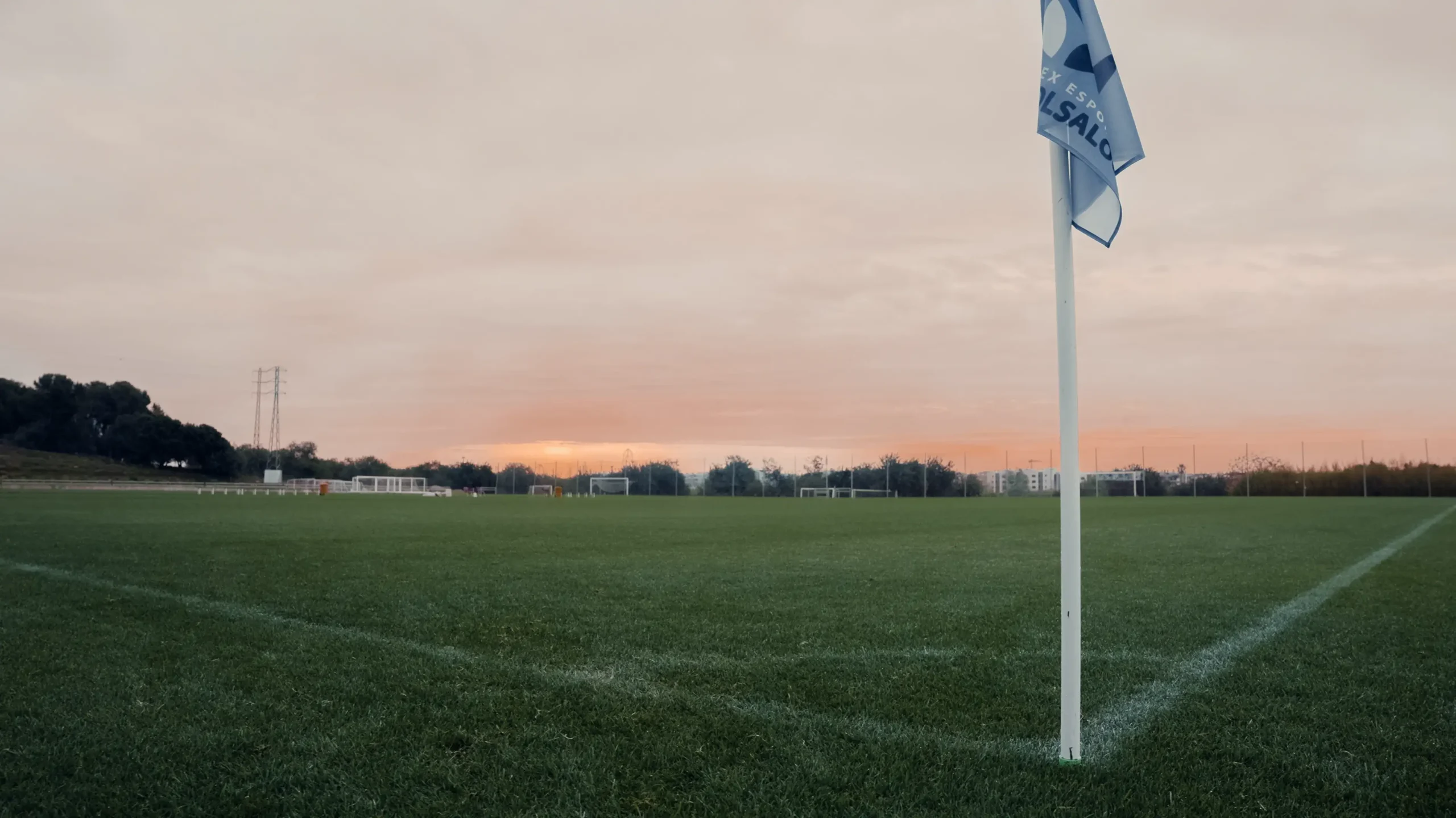 Sunset over a pitch corner flag at Futbol Salou Sports Complex